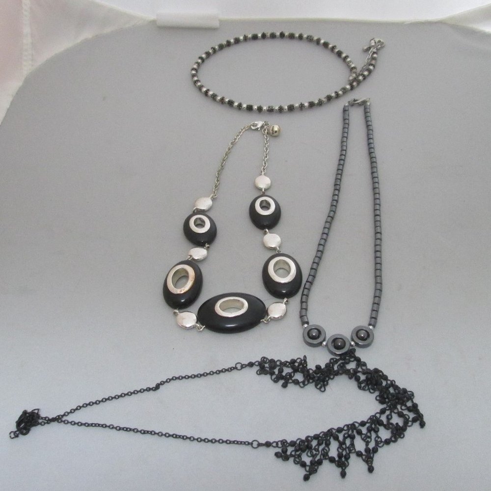 4 necklaces mostly black accents
